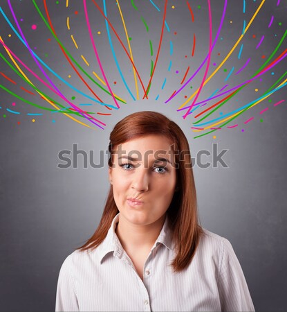 Young girl thinking with colorful abstract lines overhead Stock photo © ra2studio