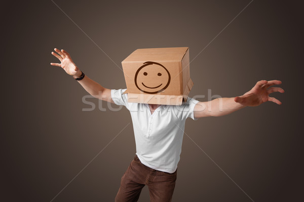 Fiatalember gesztikulál kartondoboz fej emotikon áll Stock fotó © ra2studio