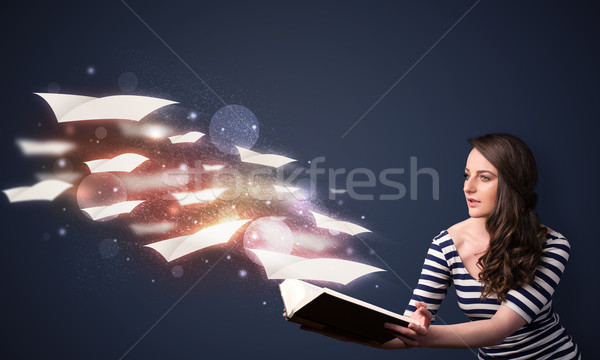 Young lady reading a book with flying sheets coming out of the b Stock photo © ra2studio