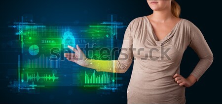 Stock photo: Young business woman touching colorful charts and diagrams