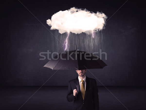 Businessman standing with umbrella and little storm cloud Stock photo © ra2studio