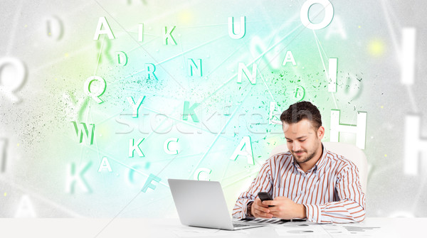Business man at desk with green word cloud Stock photo © ra2studio