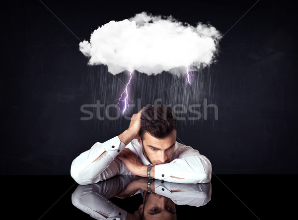 Stock photo: Depressed businessman sitting under a cloud