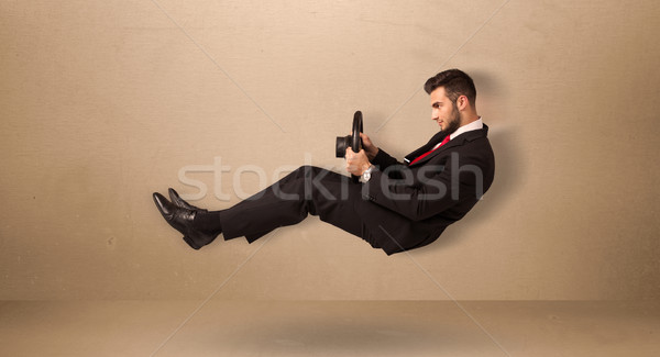 Happy funny man driving a flying car concept Stock photo © ra2studio