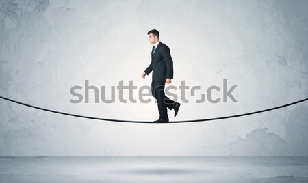 Sales guy balancing on tight rope Stock photo © ra2studio