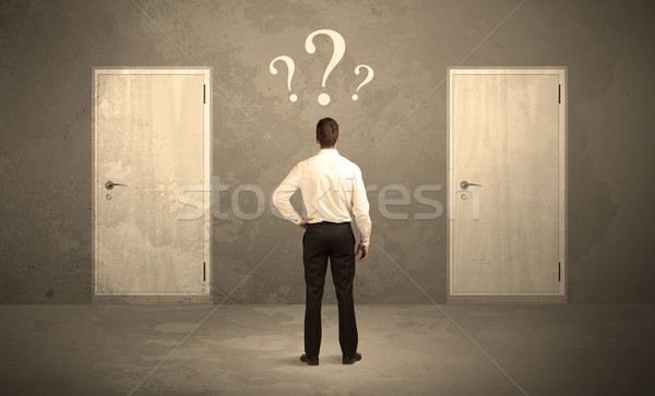 Businessman standing in front of doors Stock photo © ra2studio