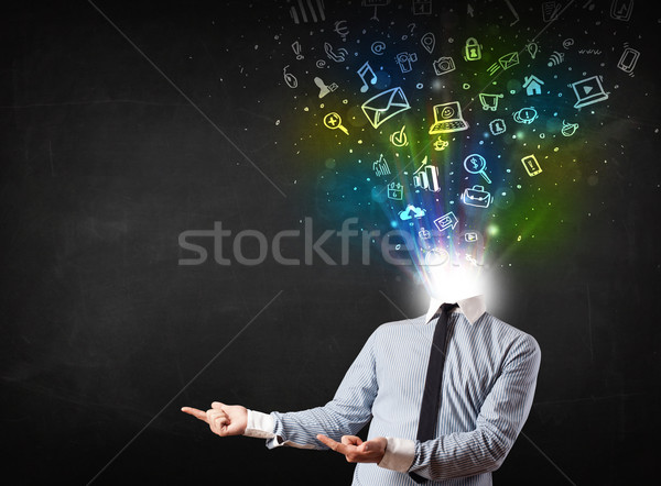 Business man with glowing media icons exploding head  Stock photo © ra2studio