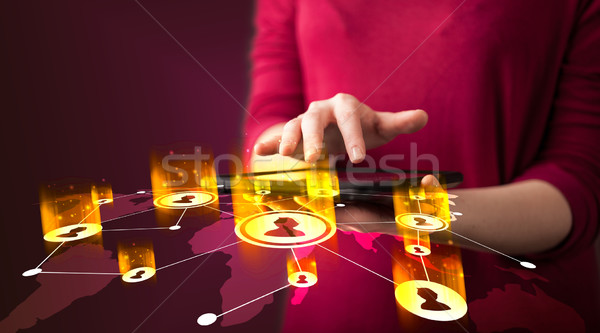 Hand holding tablet device with social network map Stock photo © ra2studio