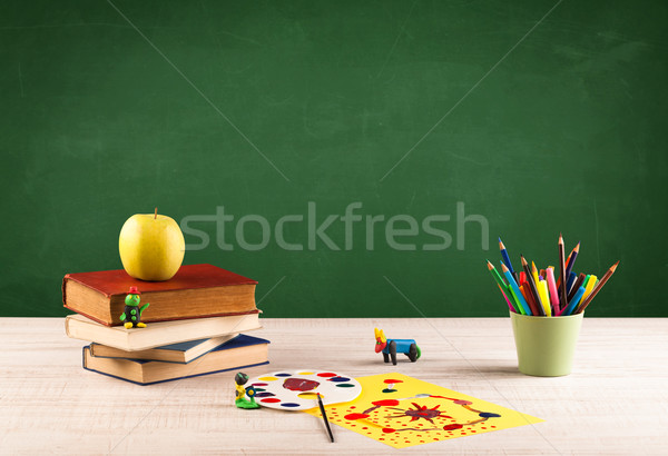 School items on desk with empty chalkboard Stock photo © ra2studio