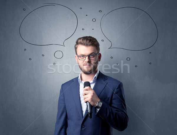 Businessman holding microphone Stock photo © ra2studio