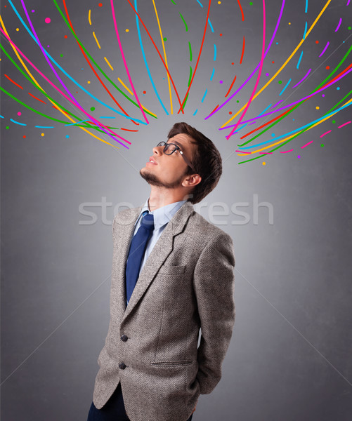 Young man thinking wiht colorful abstract lines overhead Stock photo © ra2studio