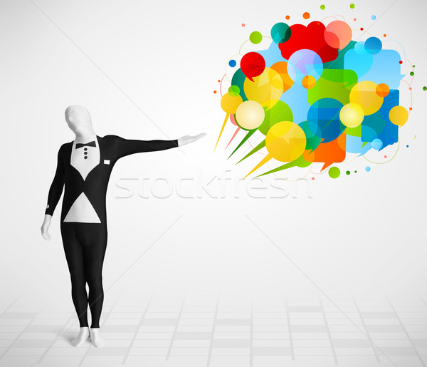 Stock photo: Strange guy in morphsuit looking at colorful speech bubbles