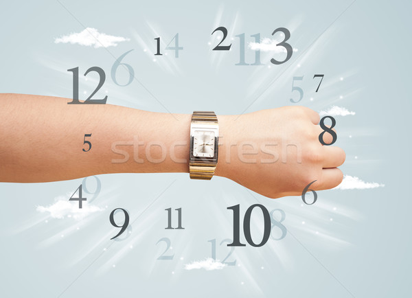 Hand with watch and numbers on the side comming out Stock photo © ra2studio