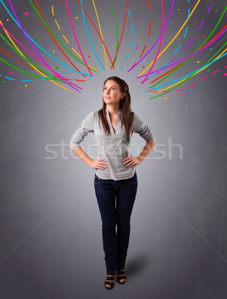 Young girl thinking with colorful abstract lines overhead Stock photo © ra2studio