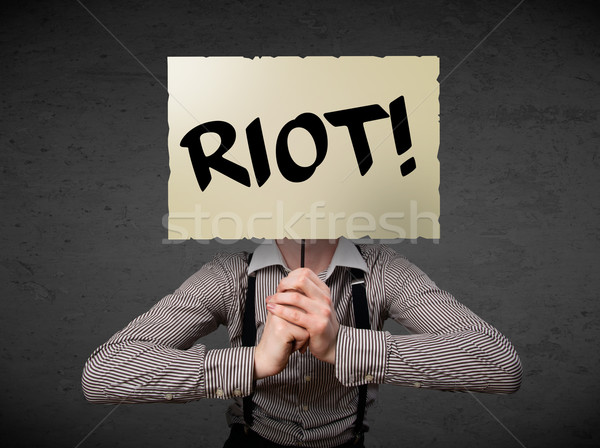Businessman holding a protest sign Stock photo © ra2studio