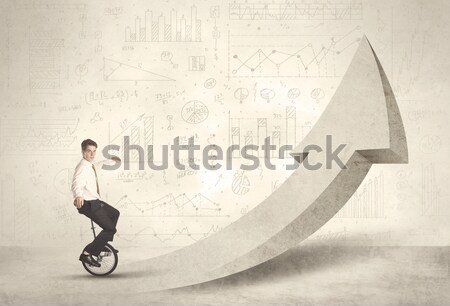 Happy business man riding a monocycle up on an arrow  Stock photo © ra2studio