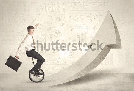 Happy business man riding a monocycle up on an arrow  Stock photo © ra2studio