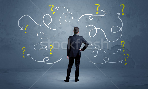 Unsure businessman with question marks Stock photo © ra2studio