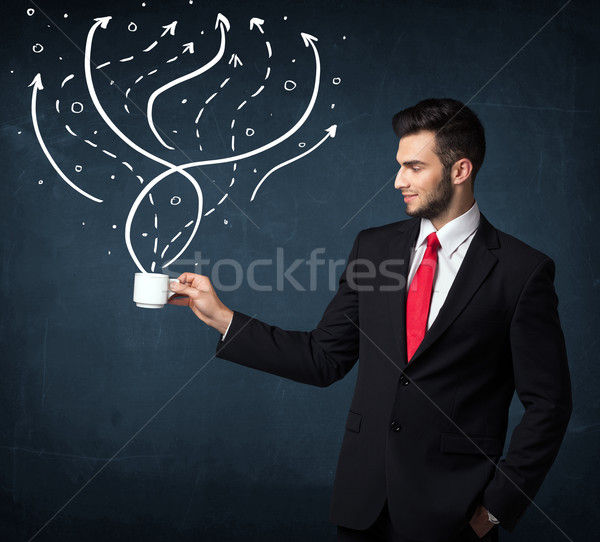 Stock photo: Businessman holding a white cup with lines and arrows