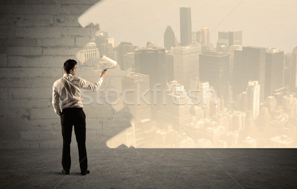 Salesman painting city scape on wall Stock photo © ra2studio