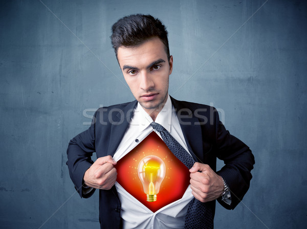 Businessman ripping off shirt and idea light bulb appears  Stock photo © ra2studio