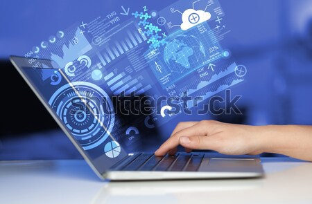 Modern notebook computer with future technology symbols Stock photo © ra2studio