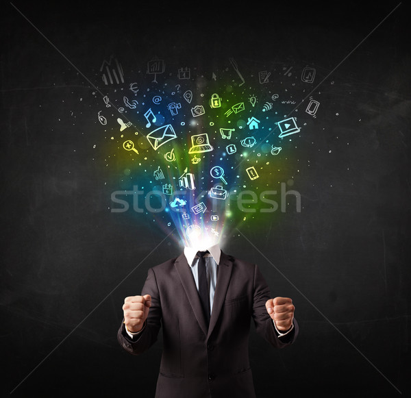 Business man with glowing media icons exploding head  Stock photo © ra2studio