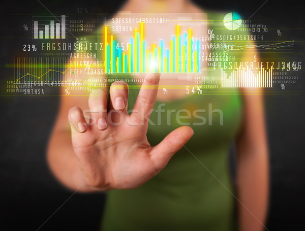Young business woman touching colorful charts and diagrams Stock photo © ra2studio
