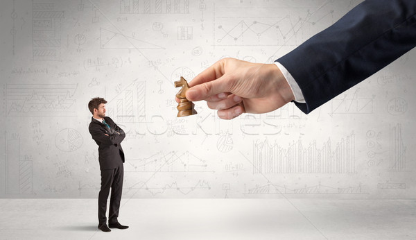 Businessman is afraid to make the next step in a chess game with Stock photo © ra2studio