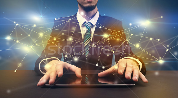 Man typing with connection graphics around Stock photo © ra2studio