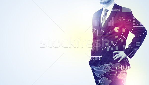 Man standing with graphs on the background Stock photo © ra2studio