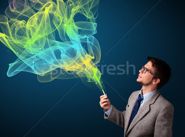 Yakışıklı adam sigara içme sigara renkli duman yakışıklı Stok fotoğraf © ra2studio