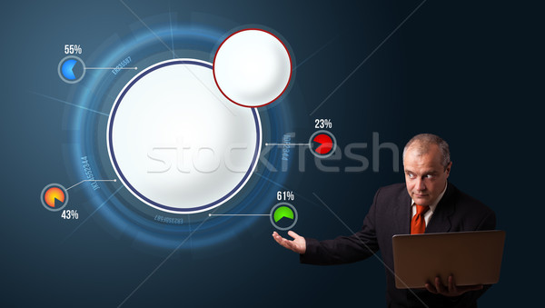 businessman in suit holding a laptop and presenting abstract modern pie chart Stock photo © ra2studio