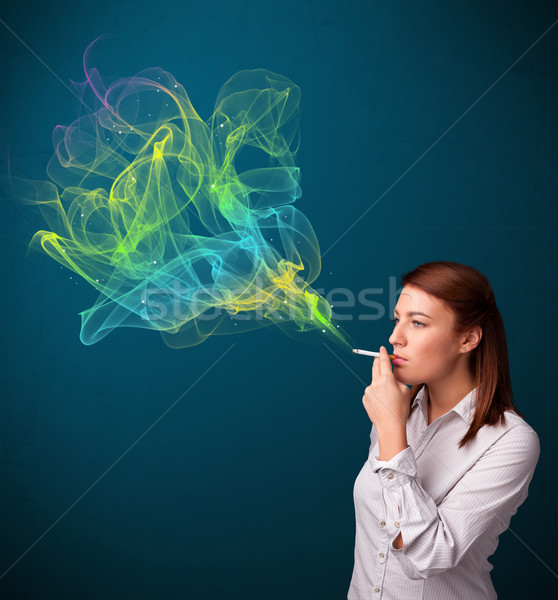 Pretty lady smoking cigarette with colorful smoke Stock photo © ra2studio