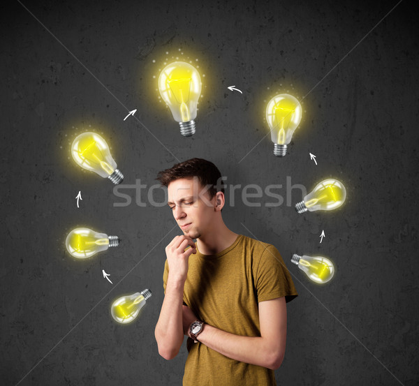 Young man thinking with lightbulb circulation around his head Stock photo © ra2studio
