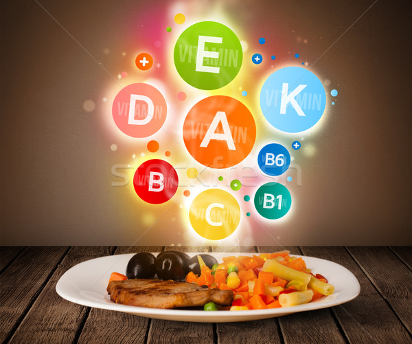 Food plate with delicious meal and healthy vitamin symbols Stock photo © ra2studio