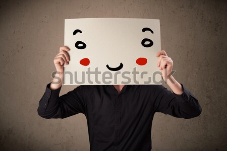 üzletember tart karton mosolygós arc fiatal kéz Stock fotó © ra2studio