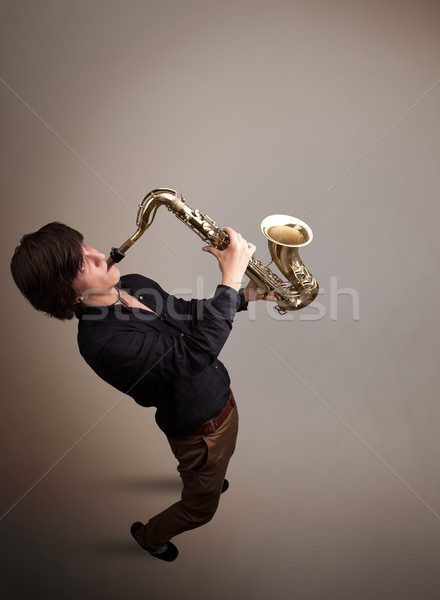 Jungen Musiker spielen Saxophon gut aussehend Musik Stock foto © ra2studio