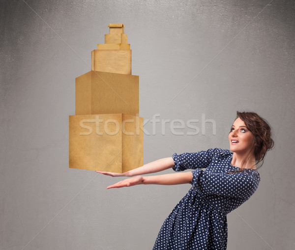 Young lady holding a set of brown cardboard boxes Stock photo © ra2studio