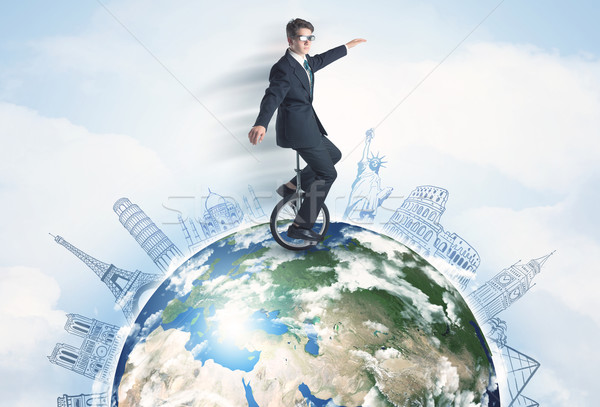 Man riding unicycle around the globe with major cities Stock photo © ra2studio