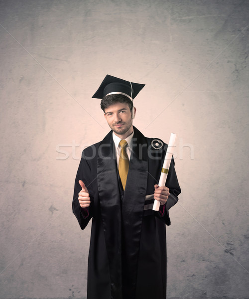 Portrait of a young graduate student on grungy background Stock photo © ra2studio