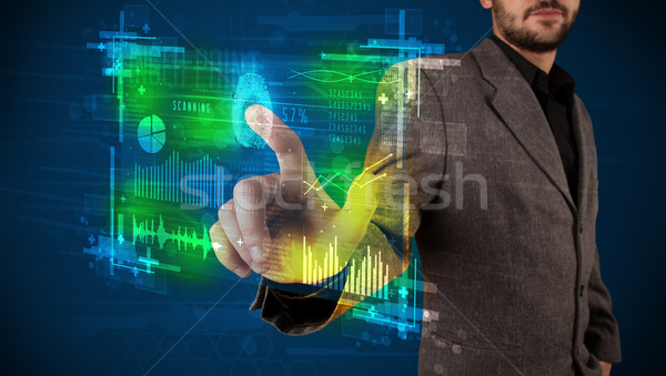 Young businessman pressing modern technology panel with finger p Stock photo © ra2studio