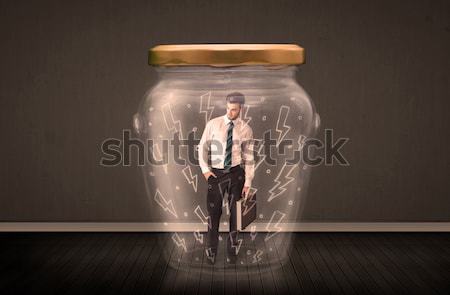 Stock photo: Businessman inside a glass jar with lightning drawings concept