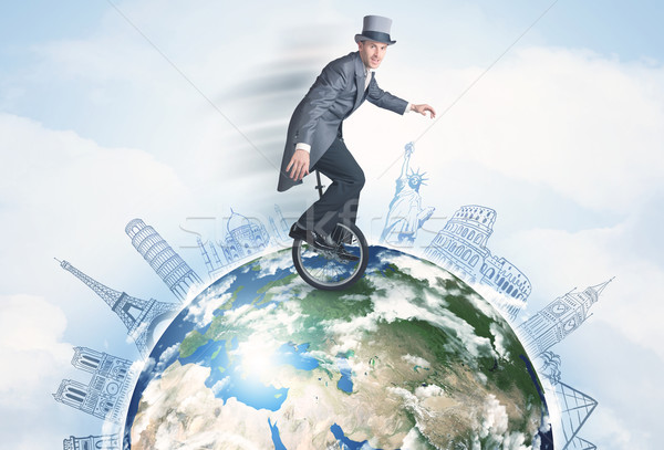 Man riding unicycle around the globe with major cities Stock photo © ra2studio