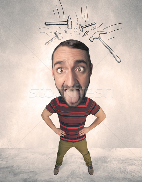 Stock photo: Big head person with drawn hammers