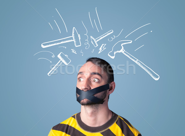 Young man with glued mouth and beating hammer marks Stock photo © ra2studio