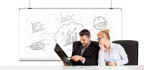 Business man and woman sitting at table with hand drawn graph ch Stock photo © ra2studio