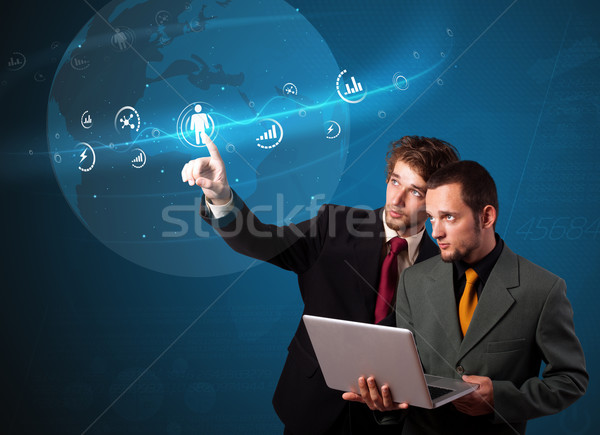 Businessman pressing modern social type of icons Stock photo © ra2studio