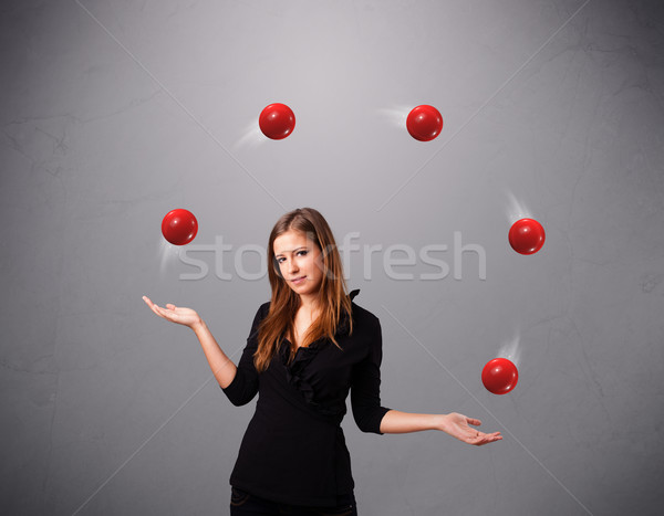 Fiatal lány áll zsonglőrködés piros golyók csinos Stock fotó © ra2studio