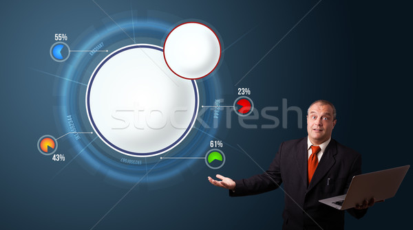 businessman in suit holding a laptop and presenting abstract modern pie chart Stock photo © ra2studio